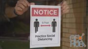 MotionArray – Man Puts Social Distance Sign On Door 1024370