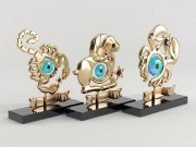 Three statuettes with zodiac signs