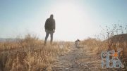MotionArray – A Person Walking With His Dog On A Field 1027939