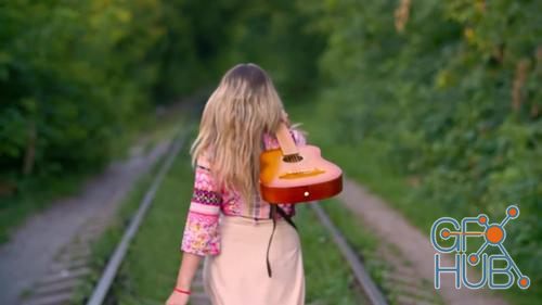 MotionArray – Woman With Guitar Walks On Railway 1026440