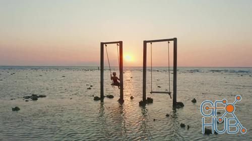 MotionArray – Tourist On Swing At Sunset Beach 1026086